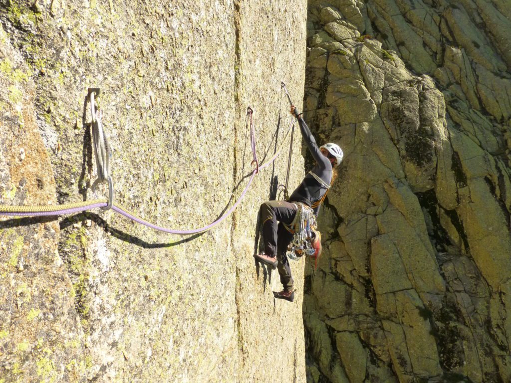 Un escalador progresa en una pared vertical